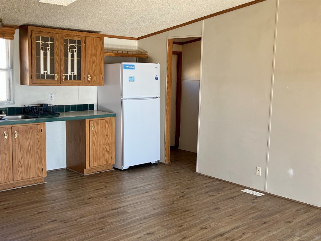 7429 Remington Road Como, CO 80432 - Photo 7 of 21 a kitchen with a refrigerator and wooden floor