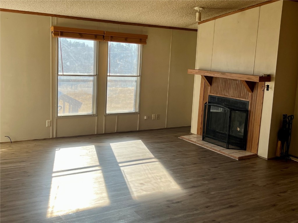 7429 Remington Road Como, CO 80432 - Photo 8 of 21 a view of empty room with wooden floor and fireplace