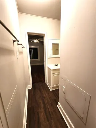 a view of a hallway and wooden floor