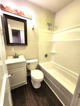 a bathroom with a toilet a sink and bathtub