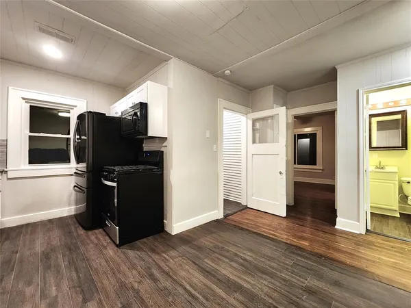 a view of a livingroom with wooden floor and furniture