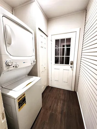 a view of washer and dryer with wooden floor