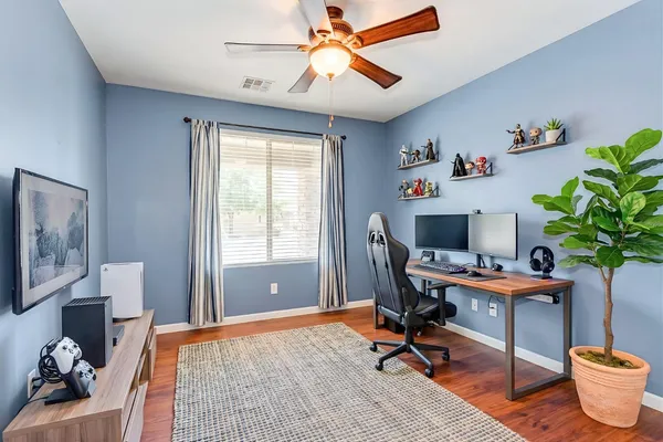 a view of a workspace with furniture and a window