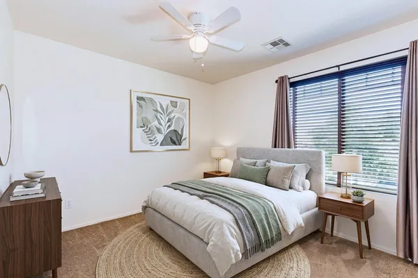 a bedroom with bed and a window