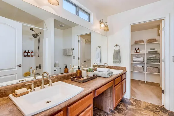 a bathroom with a sink double vanity and a mirror