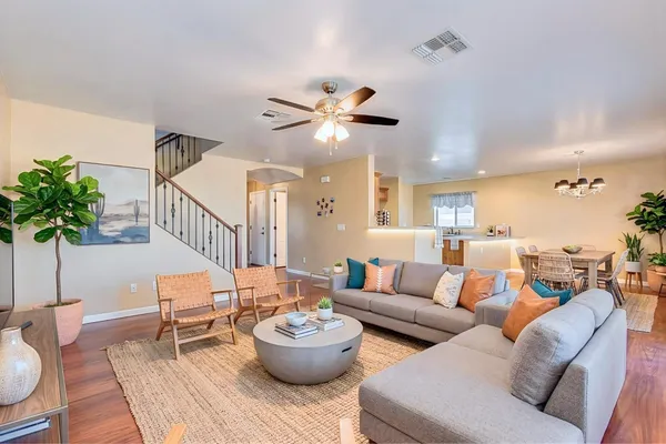 a living room with furniture and a potted plant