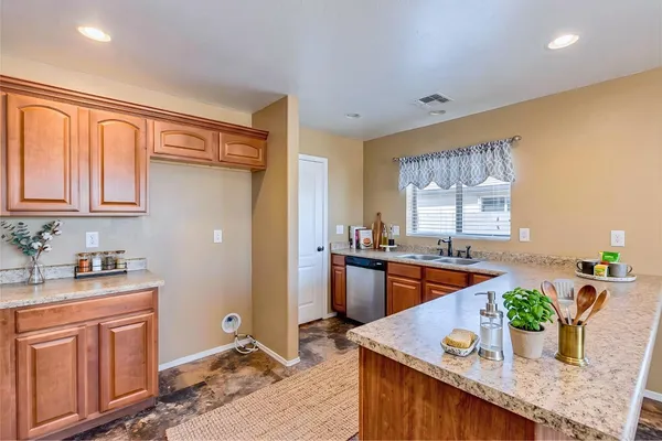 a kitchen with stainless steel appliances granite countertop sink stove top oven and cabinets