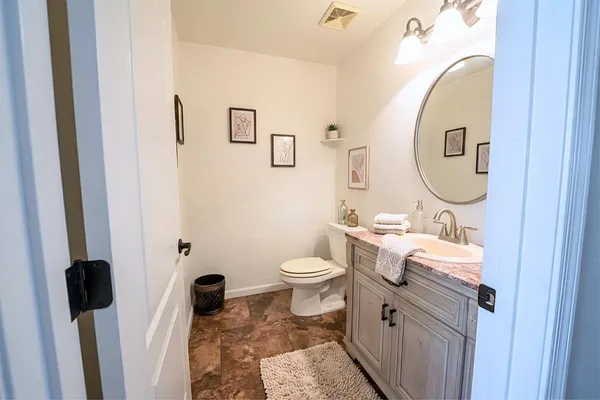 a bathroom with a toilet sink and mirror