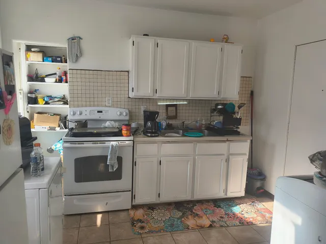 a kitchen with stainless steel appliances granite countertop a sink a stove a microwave and cabinets