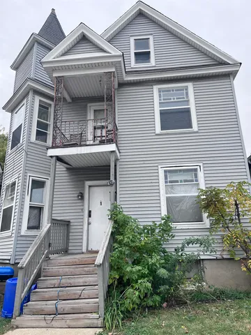 a front view of a house with plants