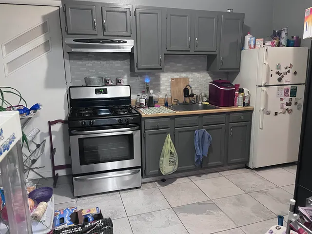 a kitchen with granite countertop cabinets and steel stainless steel appliances
