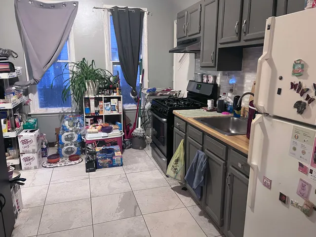 a kitchen with stainless steel appliances a sink a counter top space and cabinets