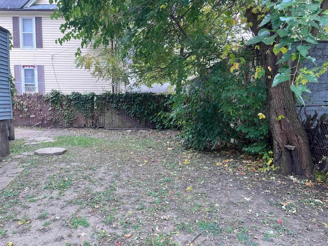 a view of a yard with a tree