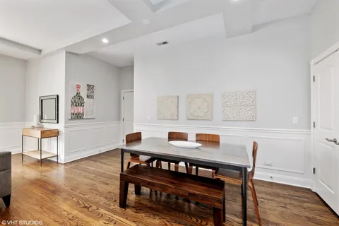 a dining room with furniture and wooden floor