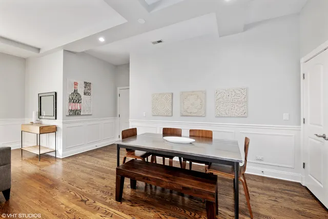 a dining room with furniture and wooden floor
