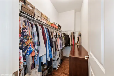 a view of walk in closet with clothes