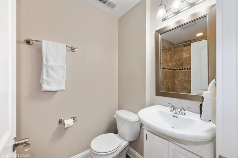 a bathroom with a sink a toilet and mirror