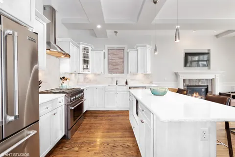 a kitchen with a sink stove and refrigerator