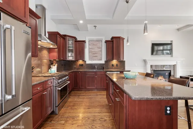 a kitchen with stainless steel appliances granite countertop a sink stove and refrigerator