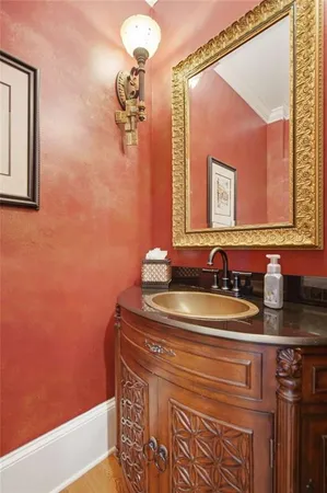 a bathroom with a granite countertop sink mirror vanity and a toilet