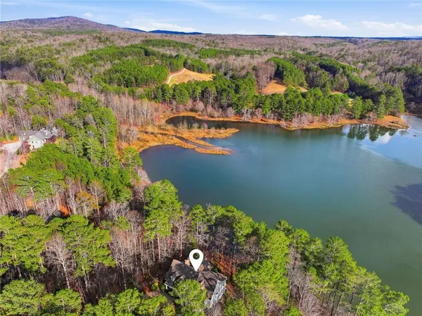 an aerial view of a houses with a lake view