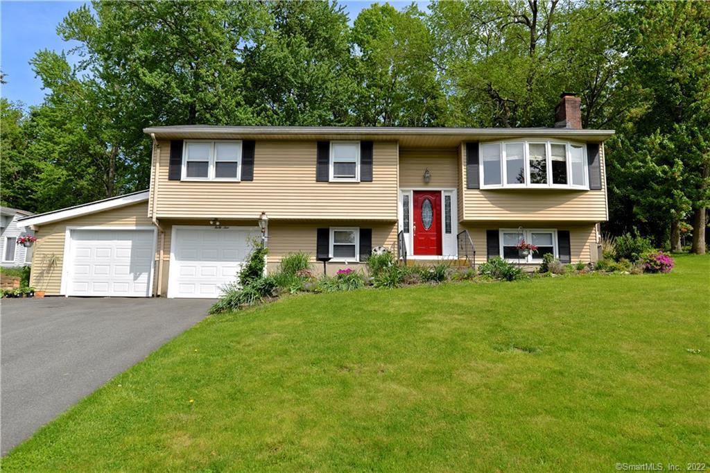 a front view of house with yard and green space