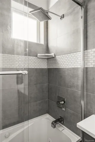 a bathroom with a shower and a sink