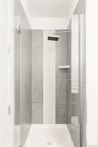 a bathroom with a shower and a bath tub