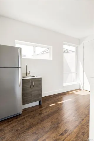 a view of a refrigerator in kitchen and wooden floor