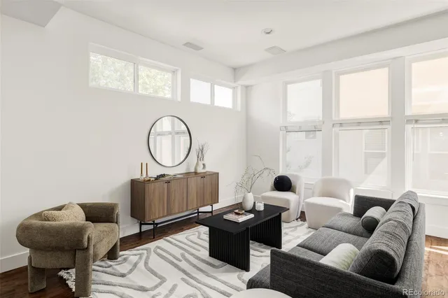 a living room with furniture a table and a large window