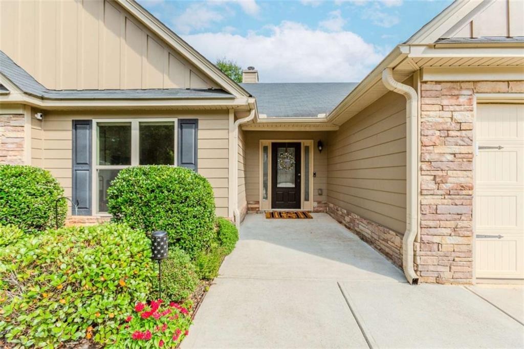 a view of a house with potted plants