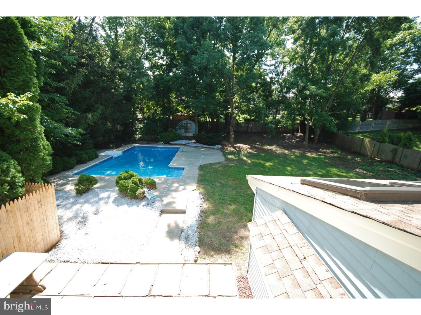 39 Lexington Road Freehold, NJ 07728 - Photo 22 of 24 a view of a backyard with a garden and fire pit