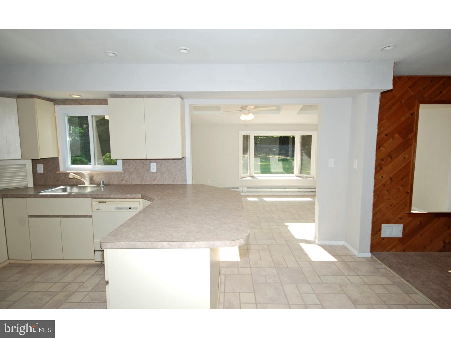 39 Lexington Road Freehold, NJ 07728 - Photo 4 of 24 a open kitchen with granite countertop a sink and a stove top oven