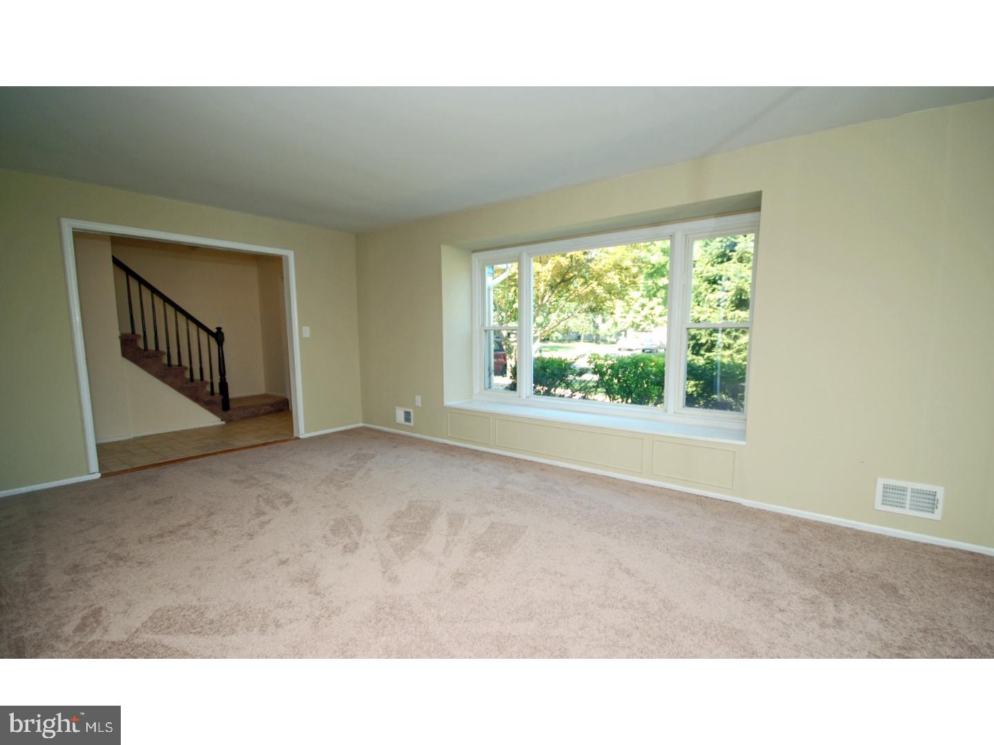 39 Lexington Road Freehold, NJ 07728 - Photo 8 of 24 a open hall with a floor to ceiling window and a projector screen