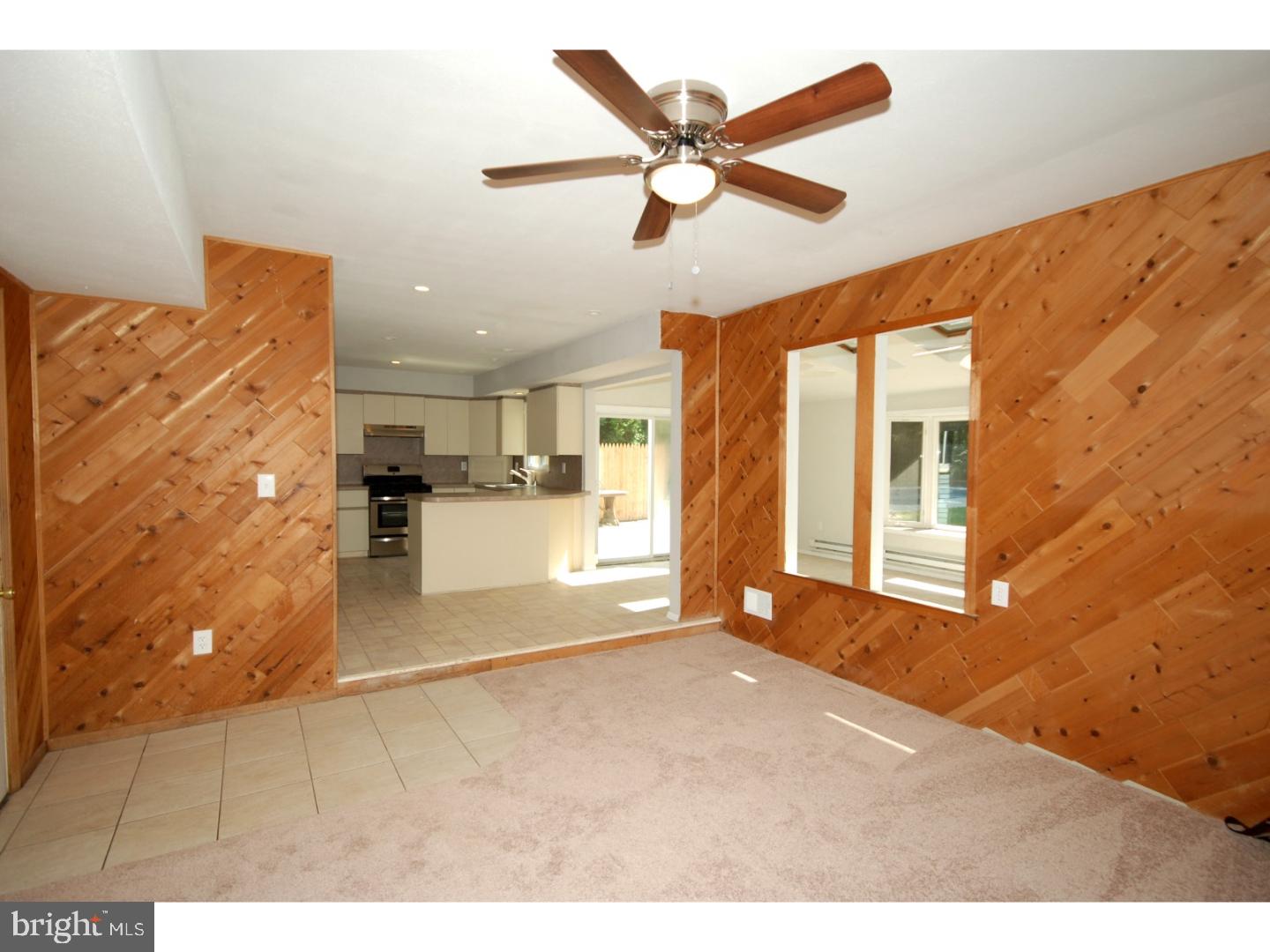 39 Lexington Road Freehold, NJ 07728 - Photo 10 of 24 a view of a livingroom with a furniture ceiling fan and window