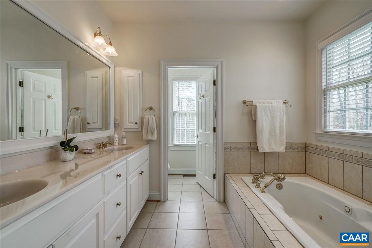 3470 Darby Road Keswick, VA 22947 - Photo 27 of 50 a bathroom with a granite countertop tub double vanity sink and mirror