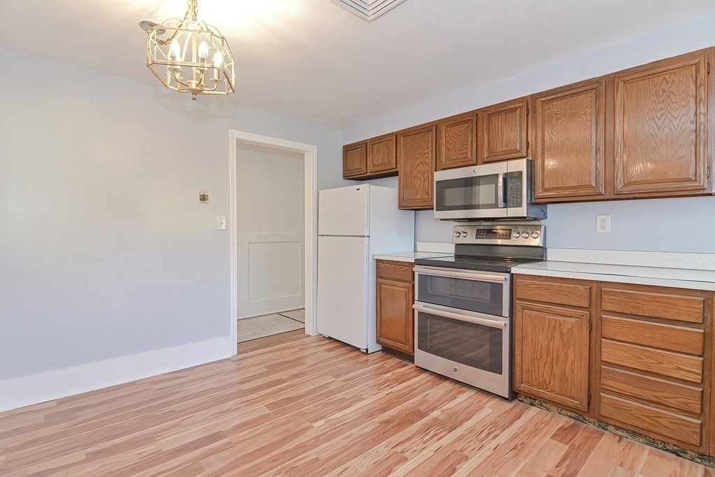 39 Dolan Road Millbury, MA 01527 - Photo 11 of 27 a kitchen with granite countertop wooden floors stainless steel appliances and cabinets