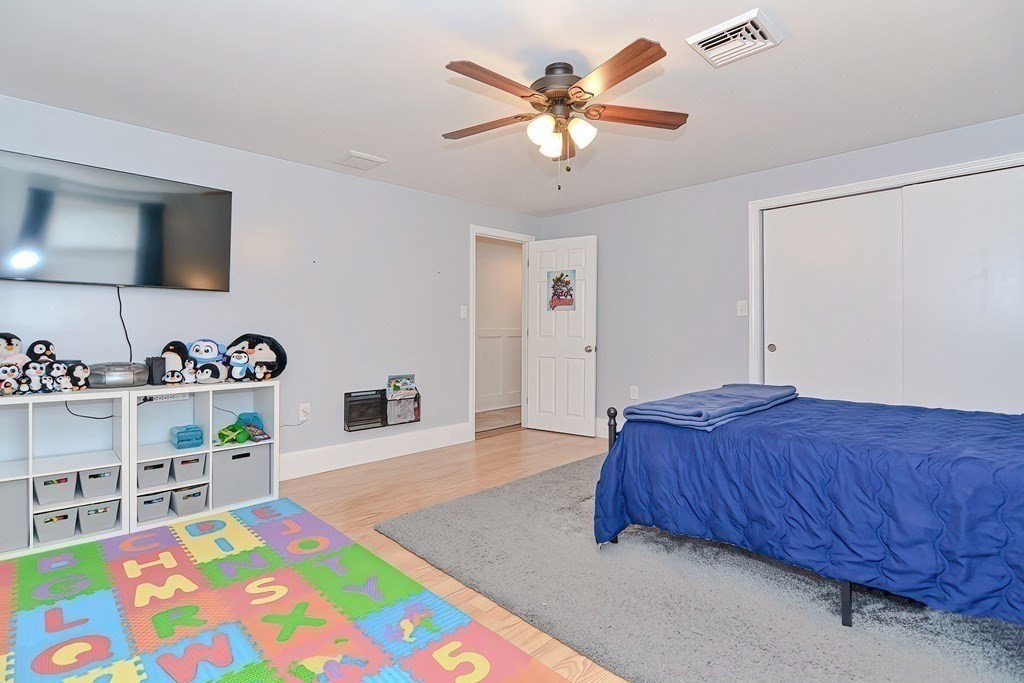 39 Dolan Road Millbury, MA 01527 - Photo 13 of 27 a bedroom with a bed and a chandelier