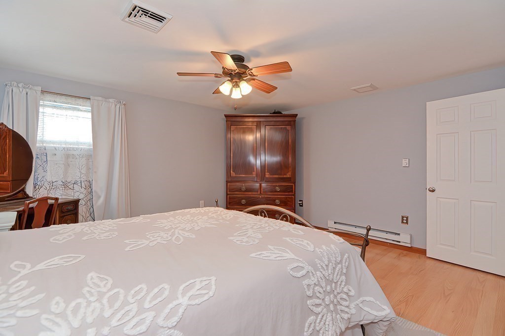 39 Dolan Road Millbury, MA 01527 - Photo 16 of 27 a bedroom with a bed and a chandelier