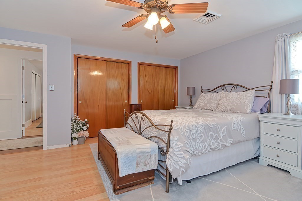 39 Dolan Road Millbury, MA 01527 - Photo 17 of 27 a bedroom with a bed and a chandelier