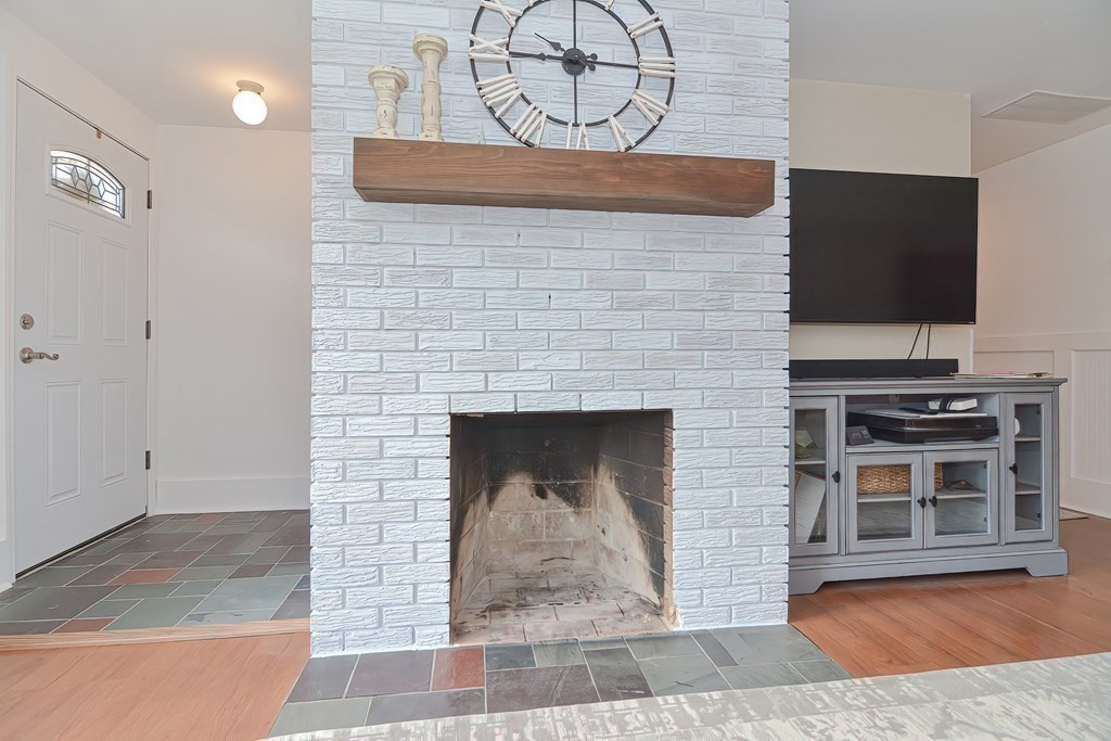 39 Dolan Road Millbury, MA 01527 - Photo 6 of 27 a stone fireplace with a rug