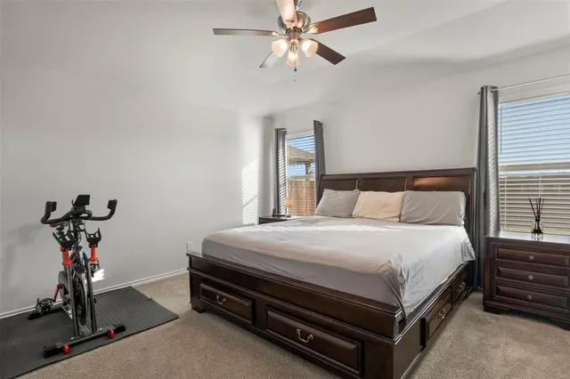 a bedroom with bed and a chandelier