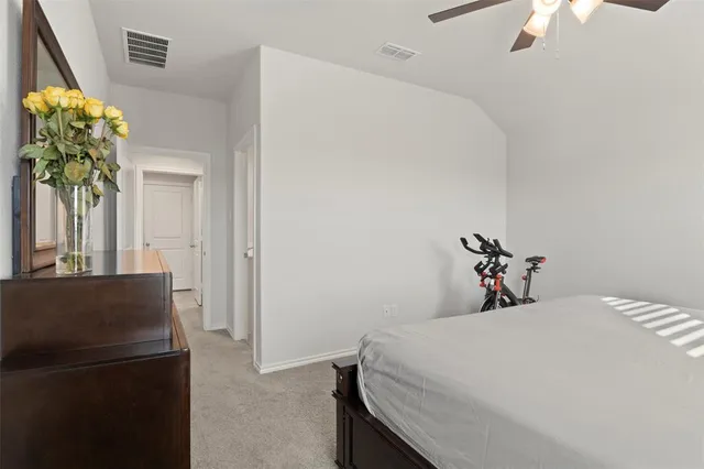 a bedroom with a bed and a potted plant