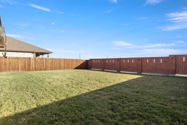 a view of a backyard with a fence