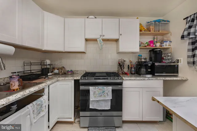 a kitchen with cabinets and appliances