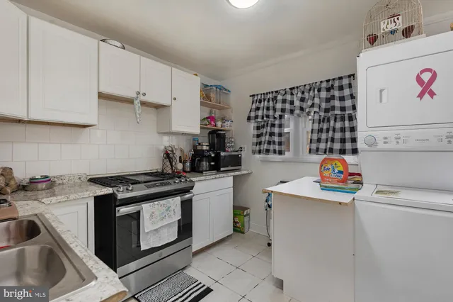 a kitchen with a sink a stove and cabinets
