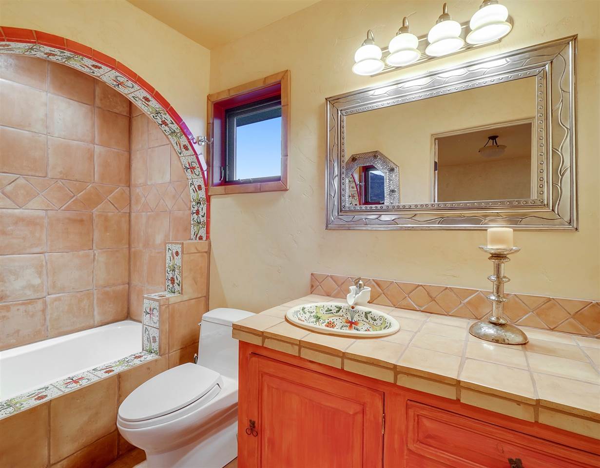 966 Mesa Drive Rifle, CO 81650 - Photo 26 of 31 a bathroom with a granite countertop toilet a sink and a mirror