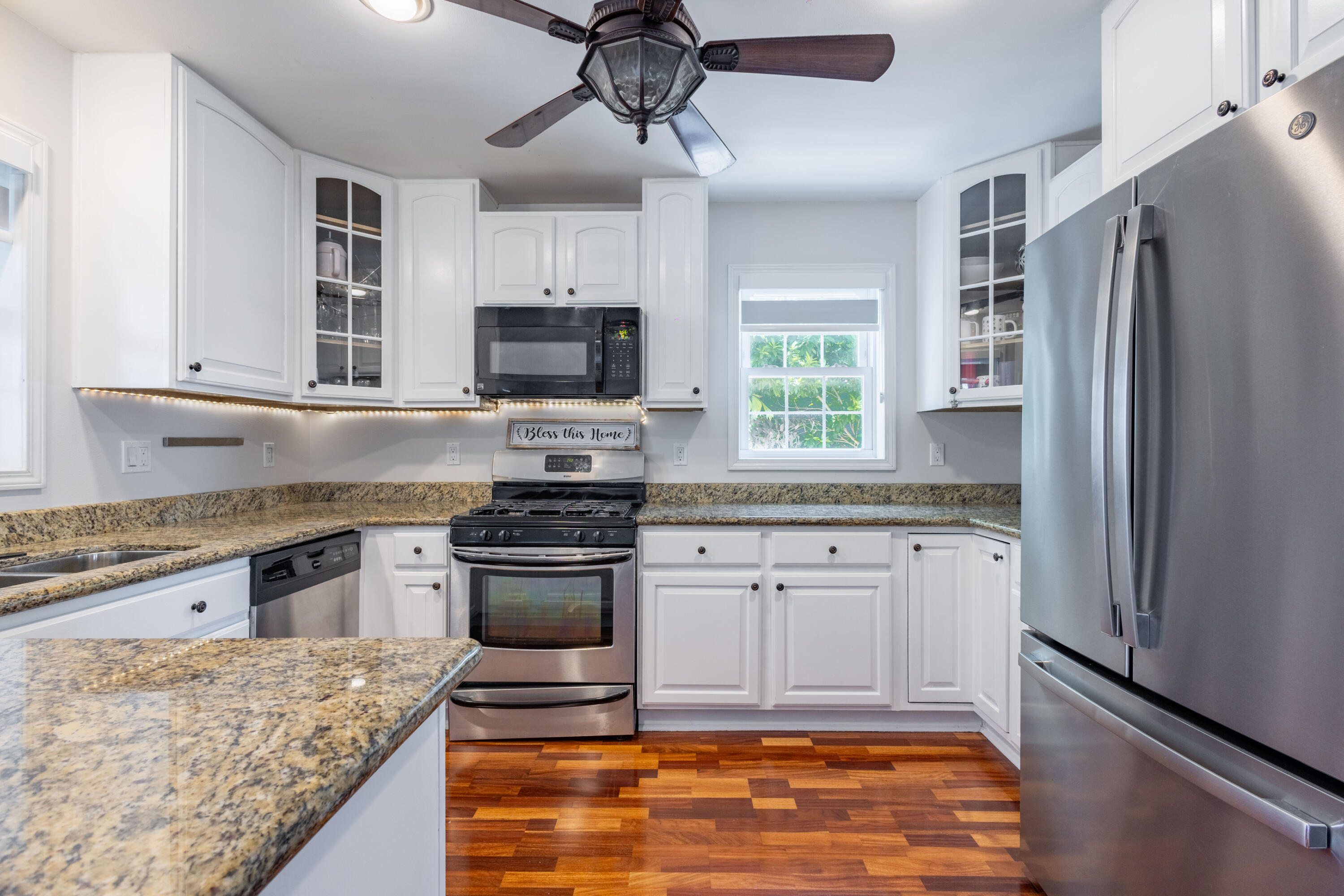 255 Mars Lane Key West, FL 33040 - Photo 11 of 43 a kitchen with stainless steel appliances granite countertop a stove refrigerator and microwave