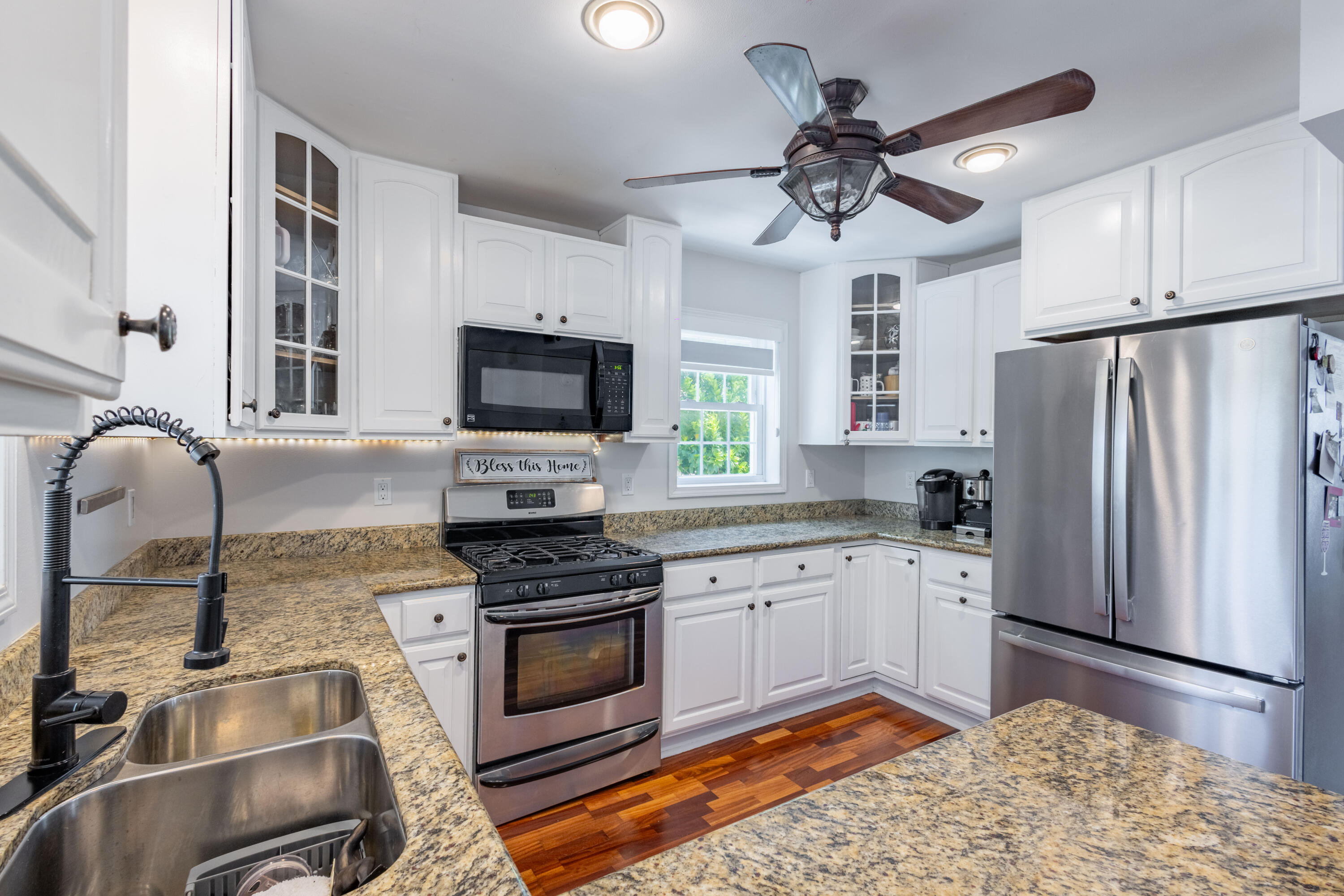 255 Mars Lane Key West, FL 33040 - Photo 12 of 43 a kitchen with stainless steel appliances granite countertop a stove refrigerator sink and microwave