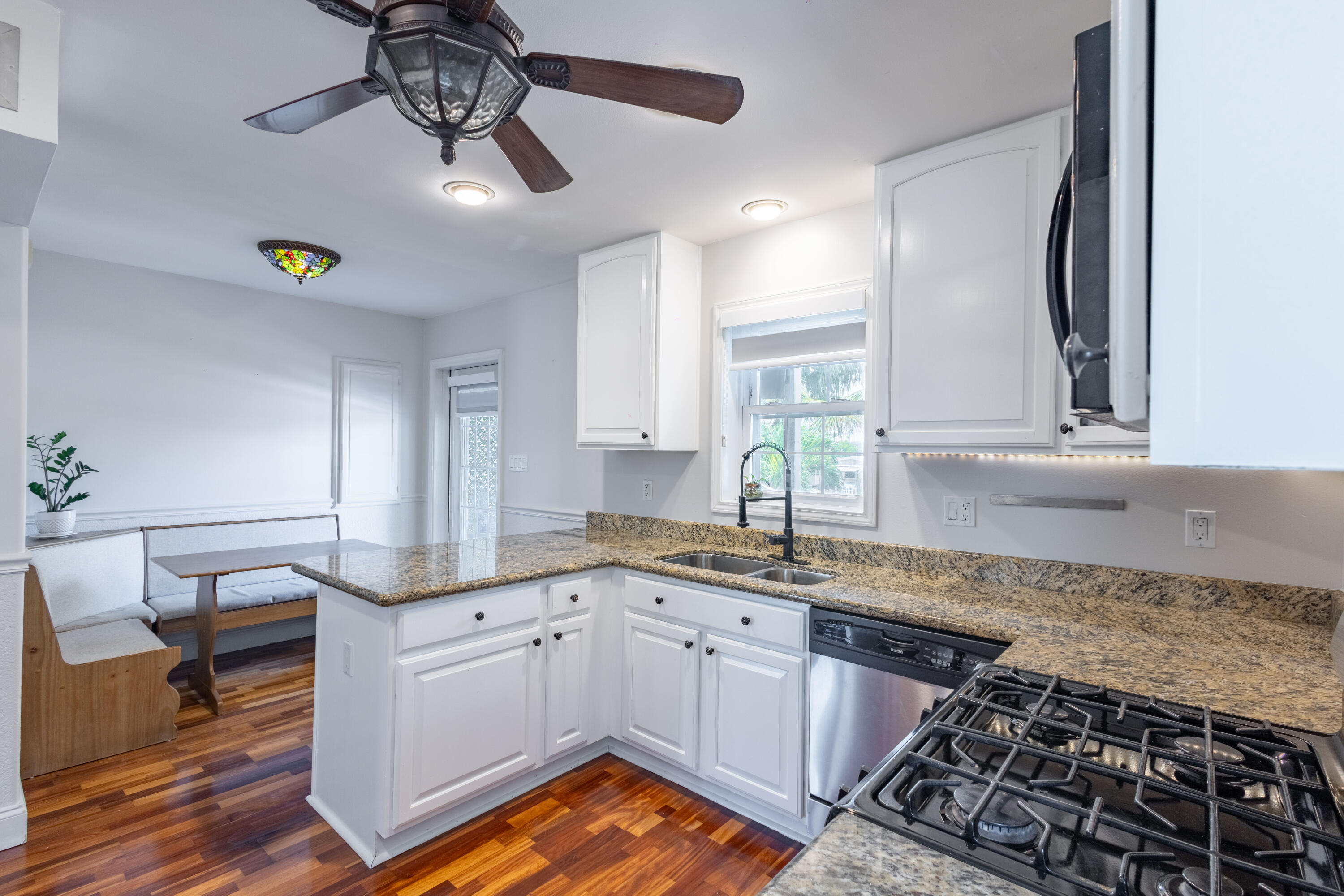 255 Mars Lane Key West, FL 33040 - Photo 13 of 43 a kitchen with granite countertop a stove a sink and a refrigerator